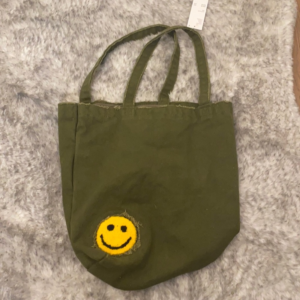 NWT Urban Outfitters Smiley Face Tote Bag. Olive canvas with yellow patch.